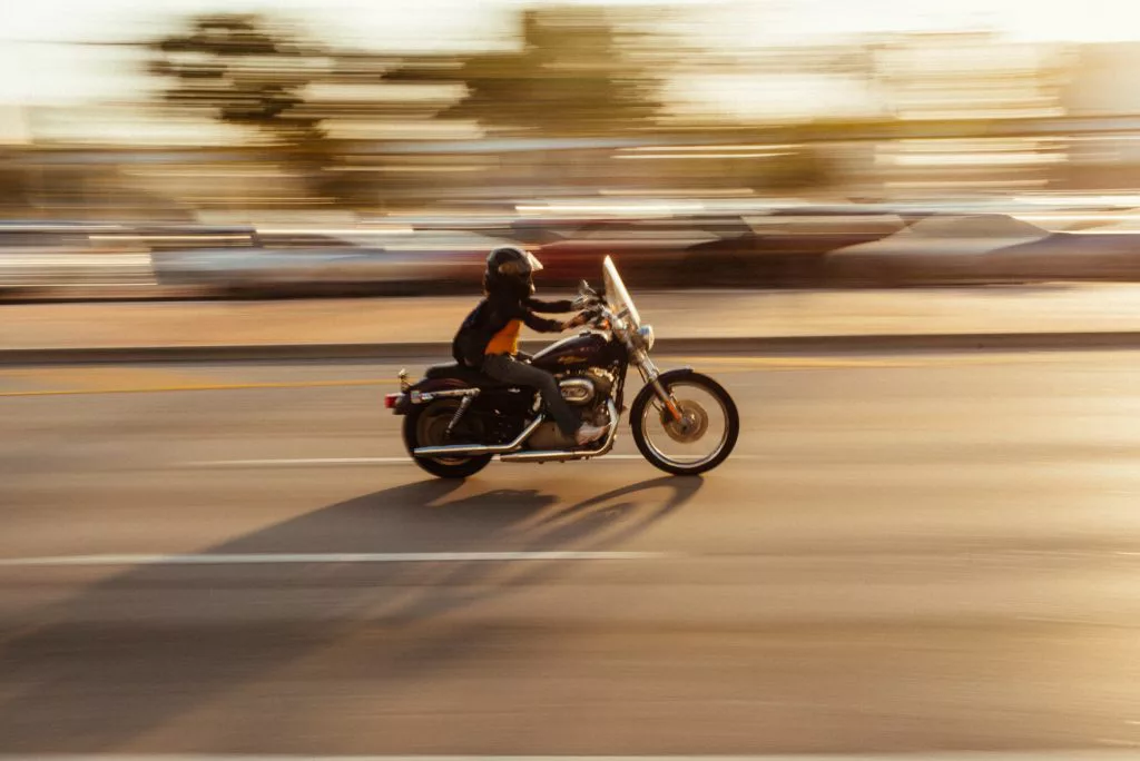 A motorcyclist speeding on a highway